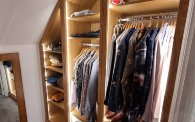 Custom-built wardrobe with oak finish and mirrored door.